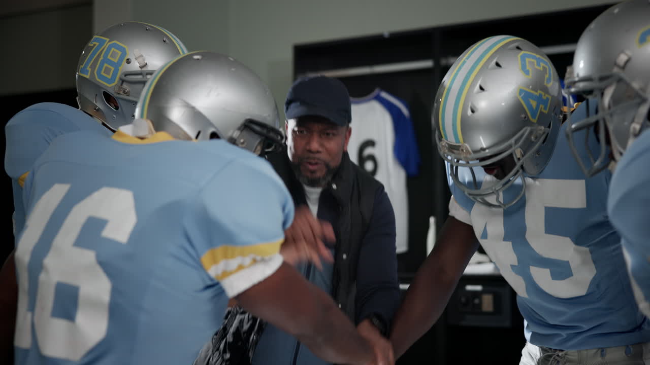 Football Team and Coach in Locker Room