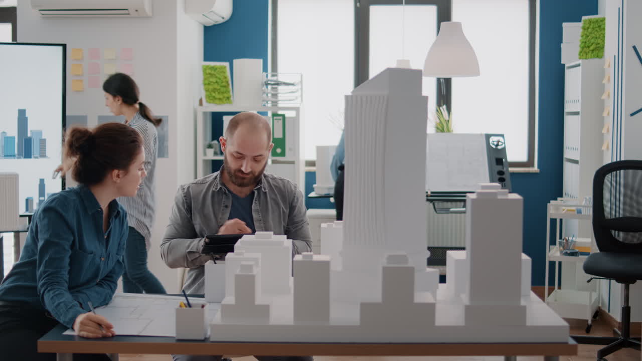 Architects collaborating on a building model in the office