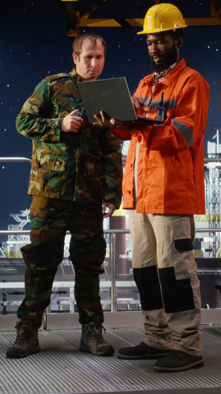 Vertical Video Military personnel on offshore vessel speak through walkie talkie