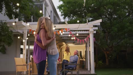 senior woman hugging her daughter outdoors