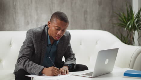 black teacher nods to cheer up answering student via laptop