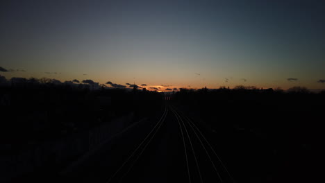 wide establishing shot of twilight on the tracks