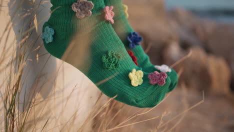 closeup funny socks moving in summer sunlight. woman legs wearing colorful pair