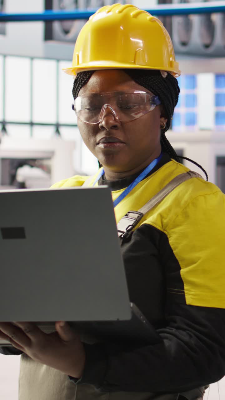 Vertical video Solar panels factory engineer analyzing data from IoT sensors