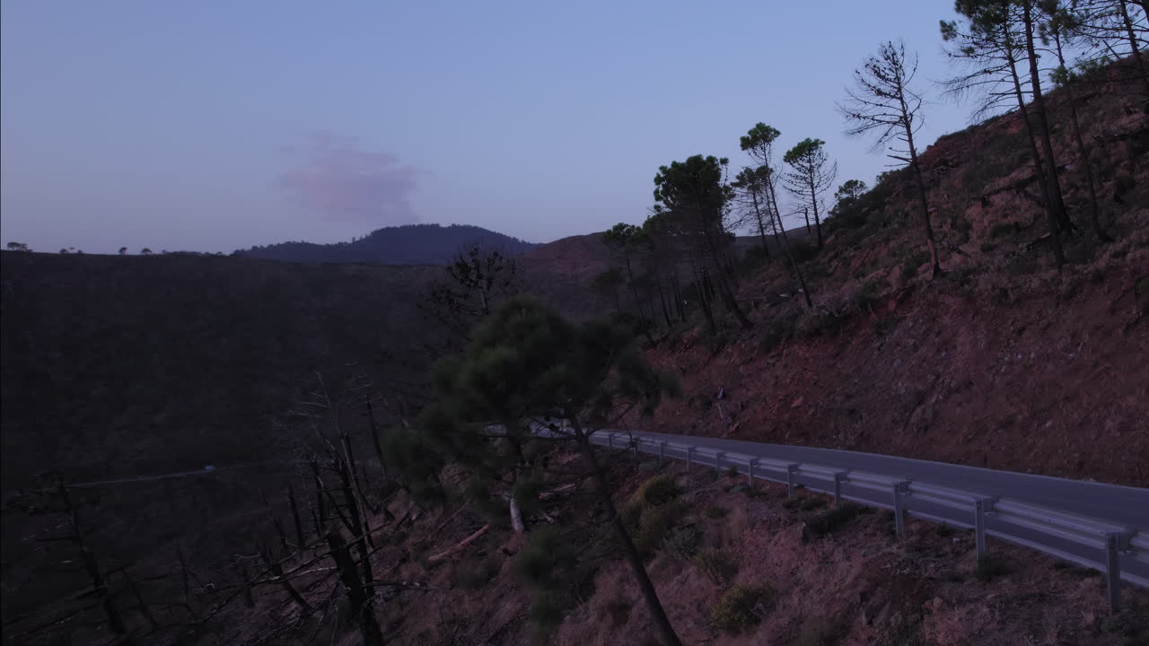 Countryside road after sundown, camera moving backwards to reveal the mountains of Sierra Bermeja, Estepona, Andalusia, Spain