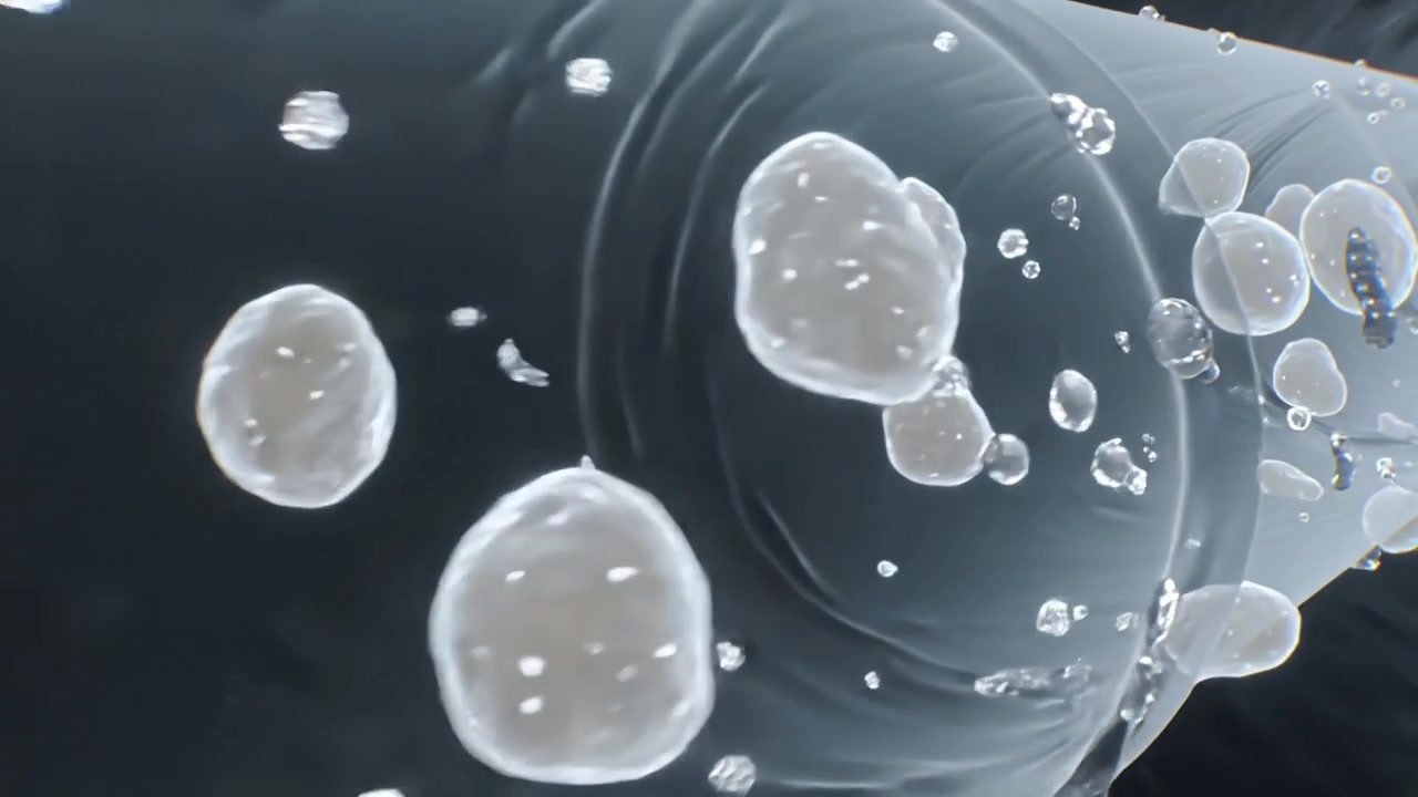 Moving camera forward in glossy tube, creamy beads and tiny drops drifting, rotating