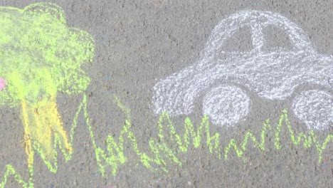 little girl with creative craft hobby drawing electro on the asphalt with chalk car environment, eco friendly, save energy in park at summer day