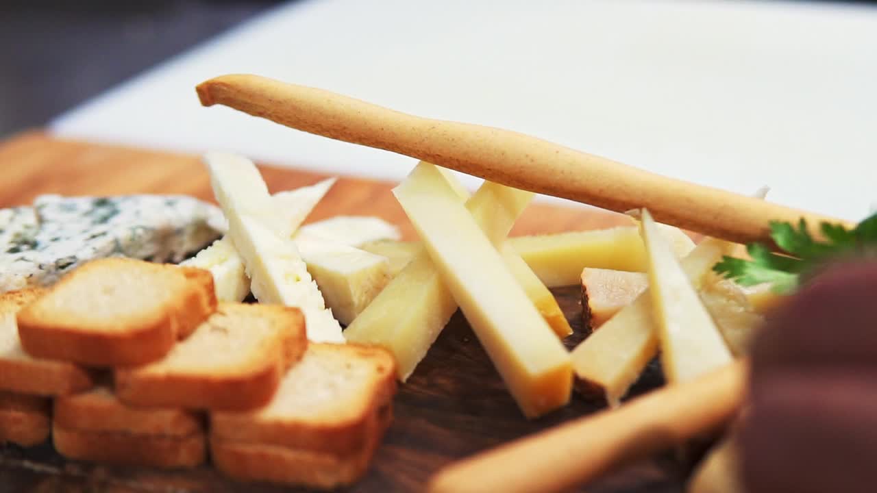 Close Up Shot Of Delicious Plate Of Cheese, Toasted Bread Vegetables With Fresh Olives