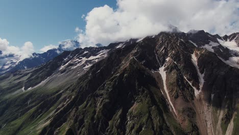 majestic mountain range with clouds and snow