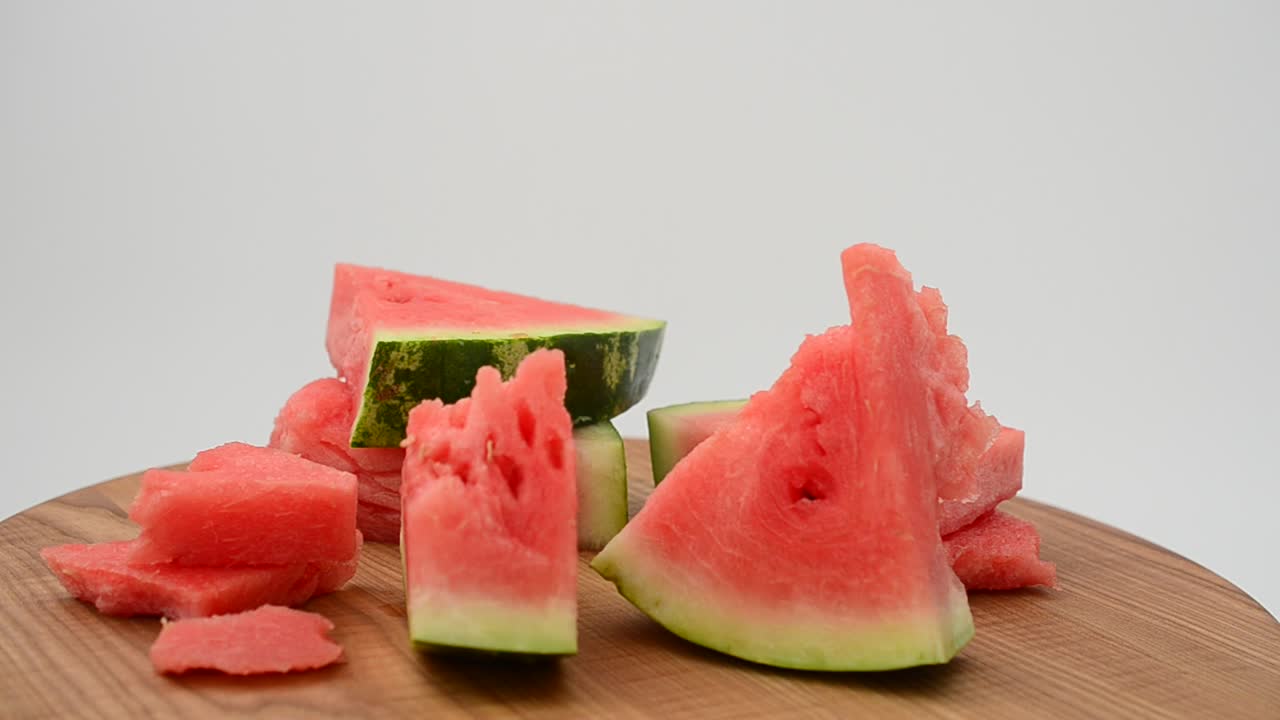 Shooting of a watermelon on a kitchen board. Shooting in the movement