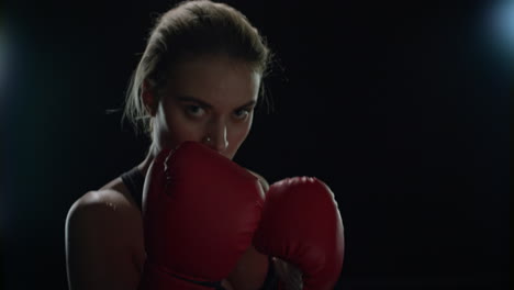 woman boxer fighting with camera