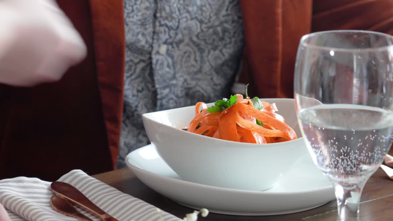 Waitress Serving Pasta Orange Noodles At Fine-Dining Restaurant. - Closeup Shot