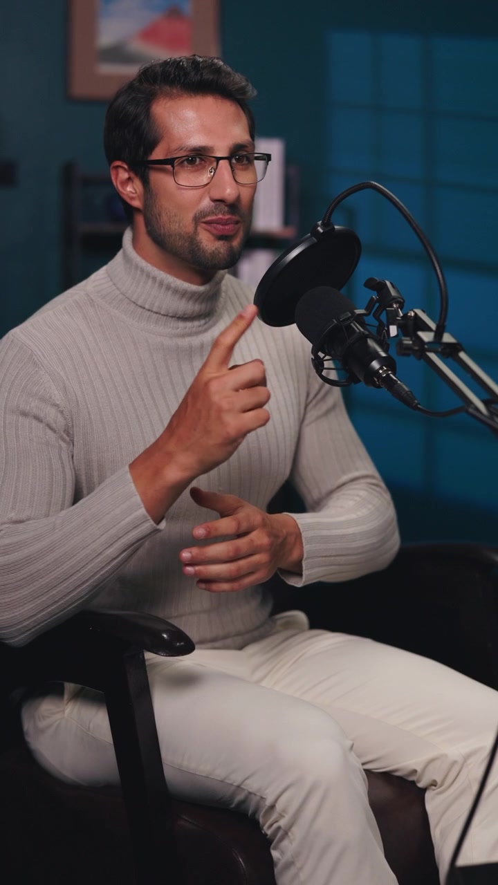 Giovane uomo che parla al microfono durante la registrazione di un podcast.