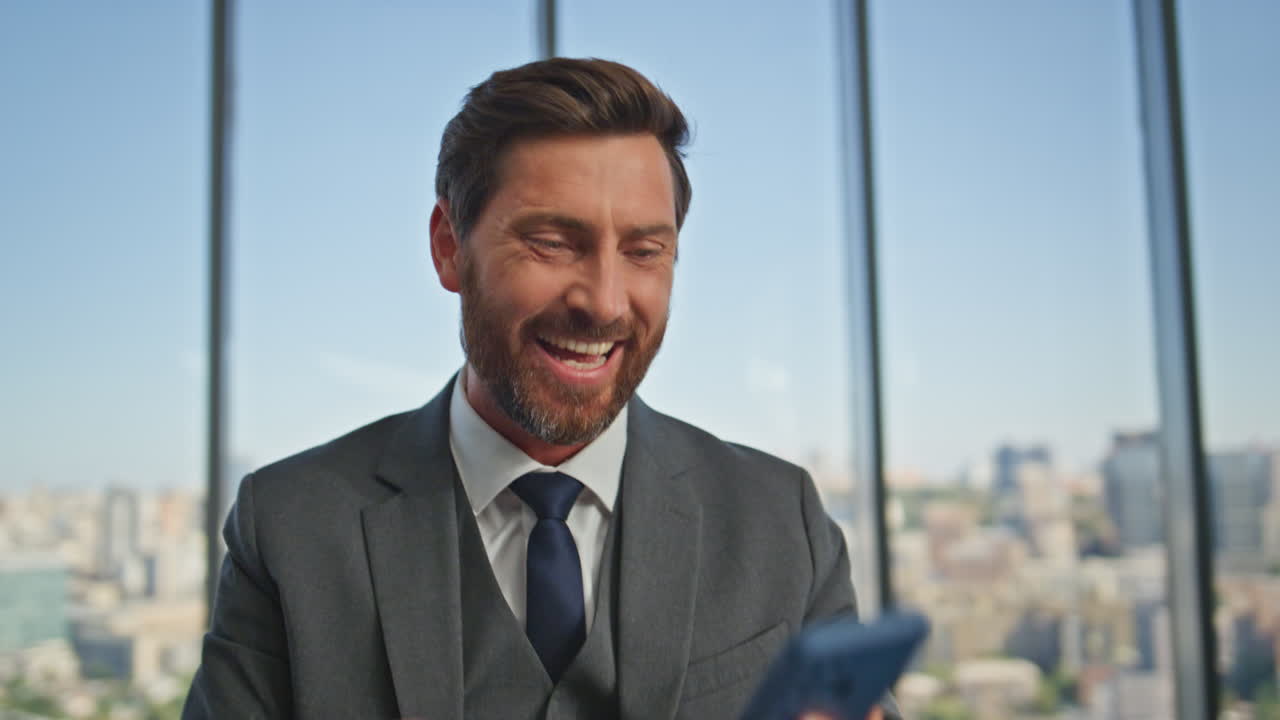 gerente alegre hablando teléfono celular hacer un trato exitoso en la oficina moderna primer plano