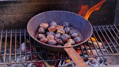 chestnuts cooked, roasted in pan over fire, traditional rustic dessert