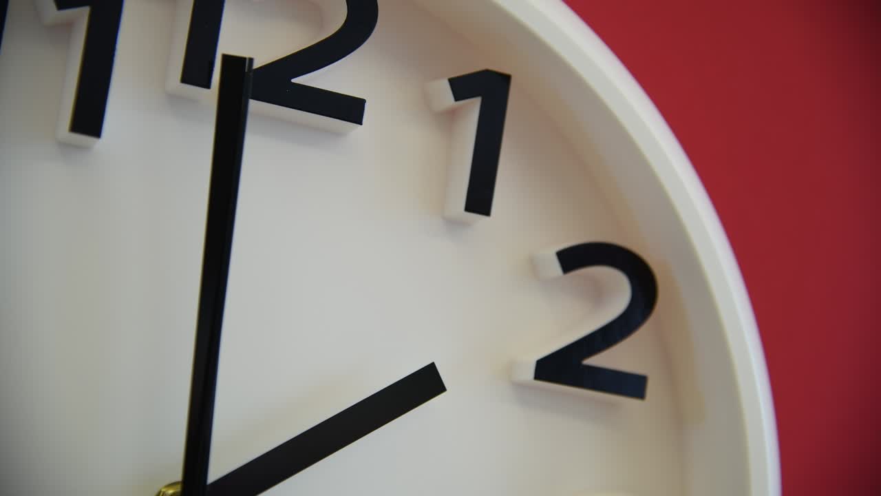 White wall clock on red background