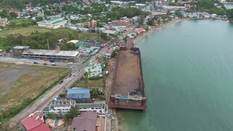 Landscape-town-view-of-Puerto-Galera,-shipwreck-stranded-at-the-coastline-after-the-quinta-typhoon-hit-the-Island