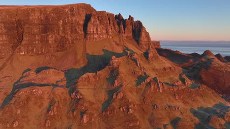 Rocky-cliffs-with-crumbling-pointed-spires-glowing-in-early-morning-light-in-winter