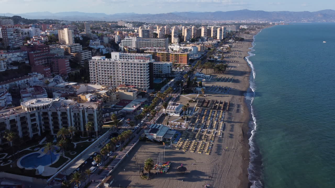 Aerial Tilt Up Reveal of Torremolinos Beach and Sunny Coastline Spain