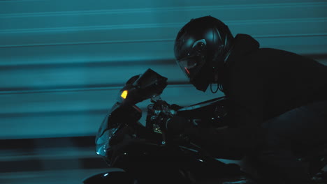 a man rides a sports motorcycle through the city at night