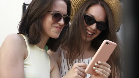 two women friends looking at a phone