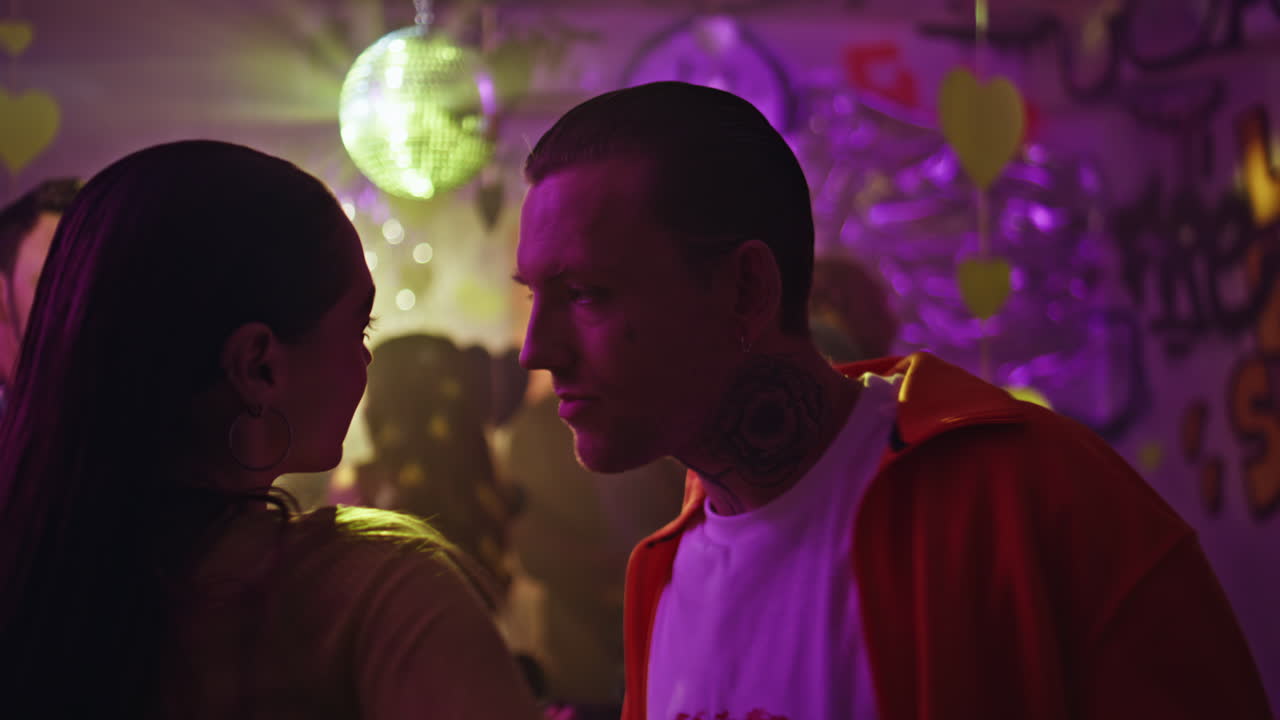 Happy sweethearts dancing club closeup. Portrait tattooed man enjoying dance