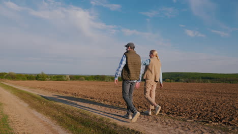 couple walking through a field