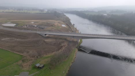 Drone footage showing the construction site and the new Destiny Bridge across Tay river in Perth, Scotland. Camera panning to the right.