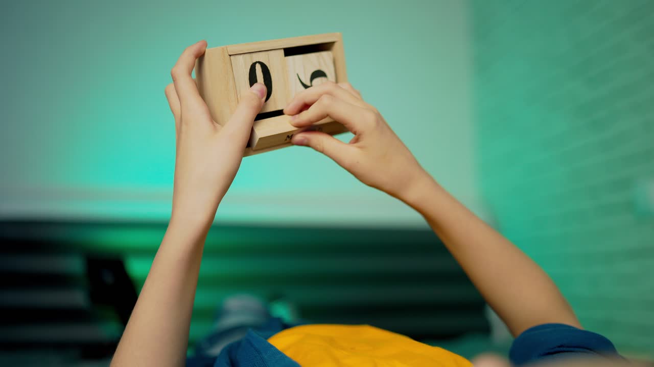 Boy holds wooden blocks. Wooden cube calendar