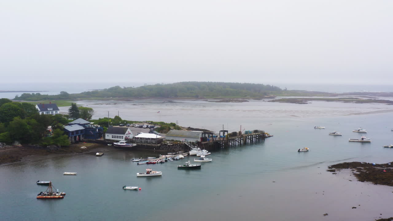 drone aerial of fishing and lobster boats sitting in marina 4k 30p