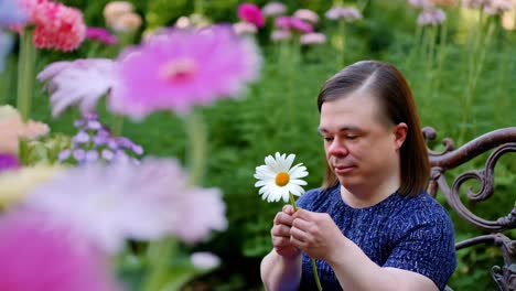 person in a garden with a daisy