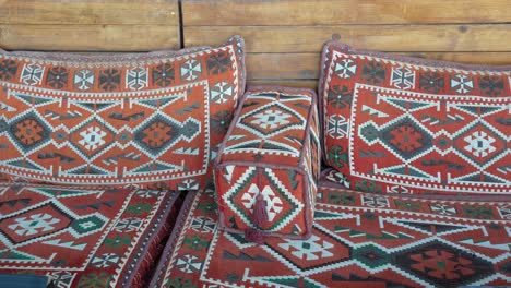 close-up of colorful ethnic pillows and ottoman