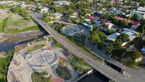 aerial view of new infrastructure developments of new children's playground and habibie bridge over inner city centre river in capital dili, timor leste, southeast asia