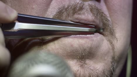 man playing a mouth harp