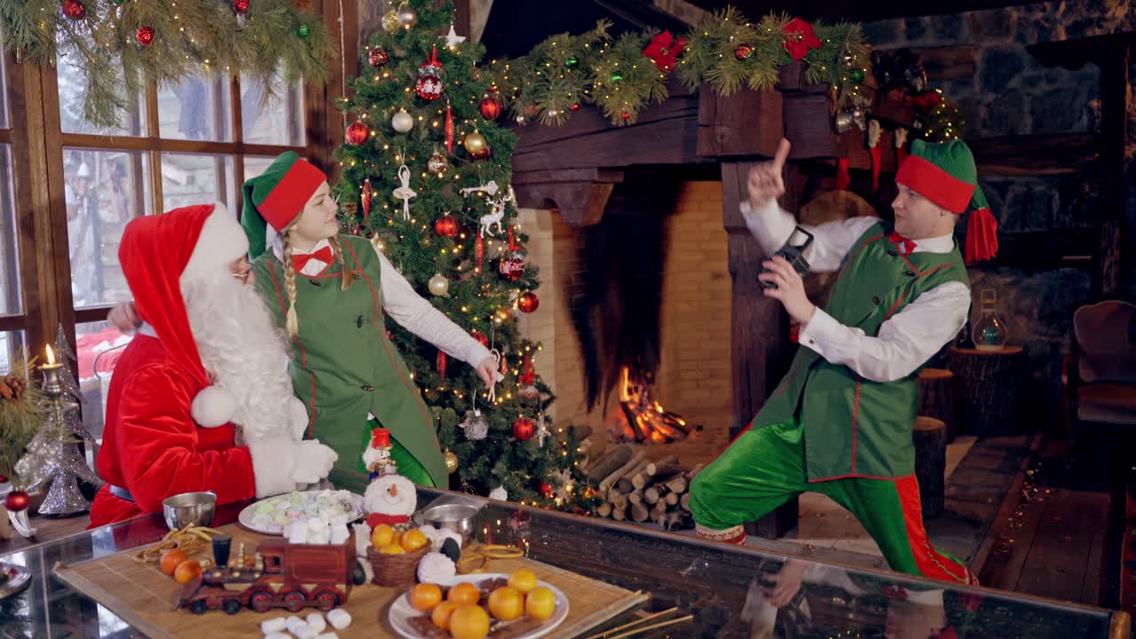 Santa Claus makes shot on camera. Funny Santa in fashionable coat takes photos