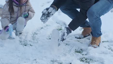 grandfather and granddaughter having fun in the snow