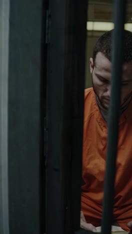 inmate reading in prison cell