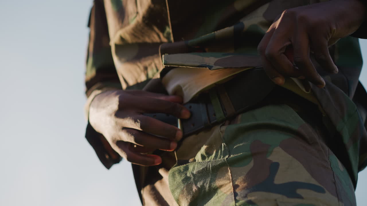 Utility Strap Securing Gear Tightly, Outdoor Operative Attaching Durable Utility Strap With Precision, Military Operative Adjusting Rough Textured Belt Buckle For Field Deployment Readiness