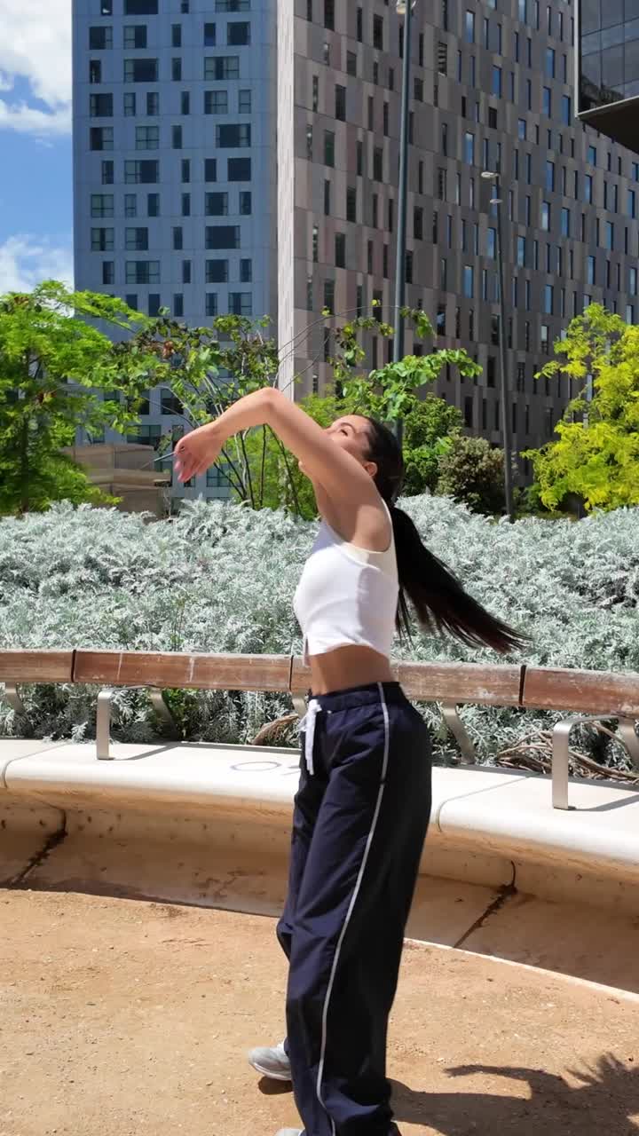 Woman dancing in an urban park