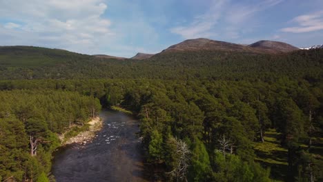 scotland countryside drone shot of river and mountain in distance