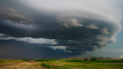 ominous supercell storm cloud over rural landscape with rv