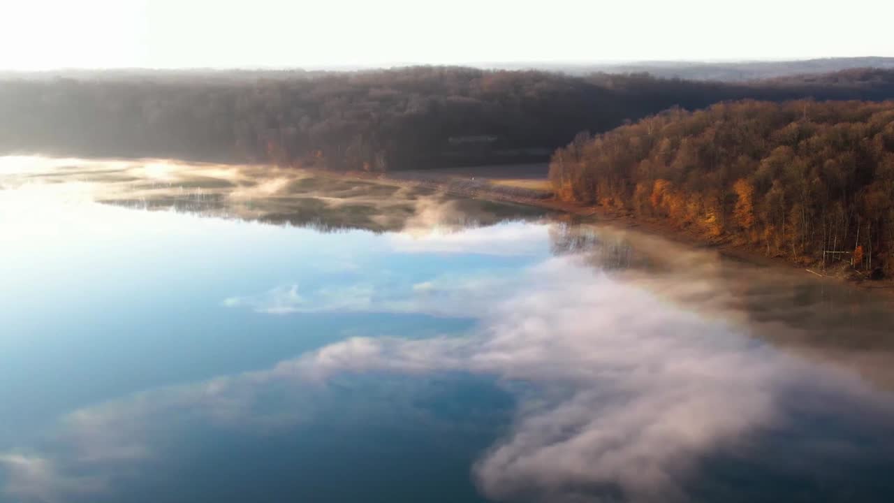 Wide aerial view of Lake Monroe in Indiana on a bright and foggy morning