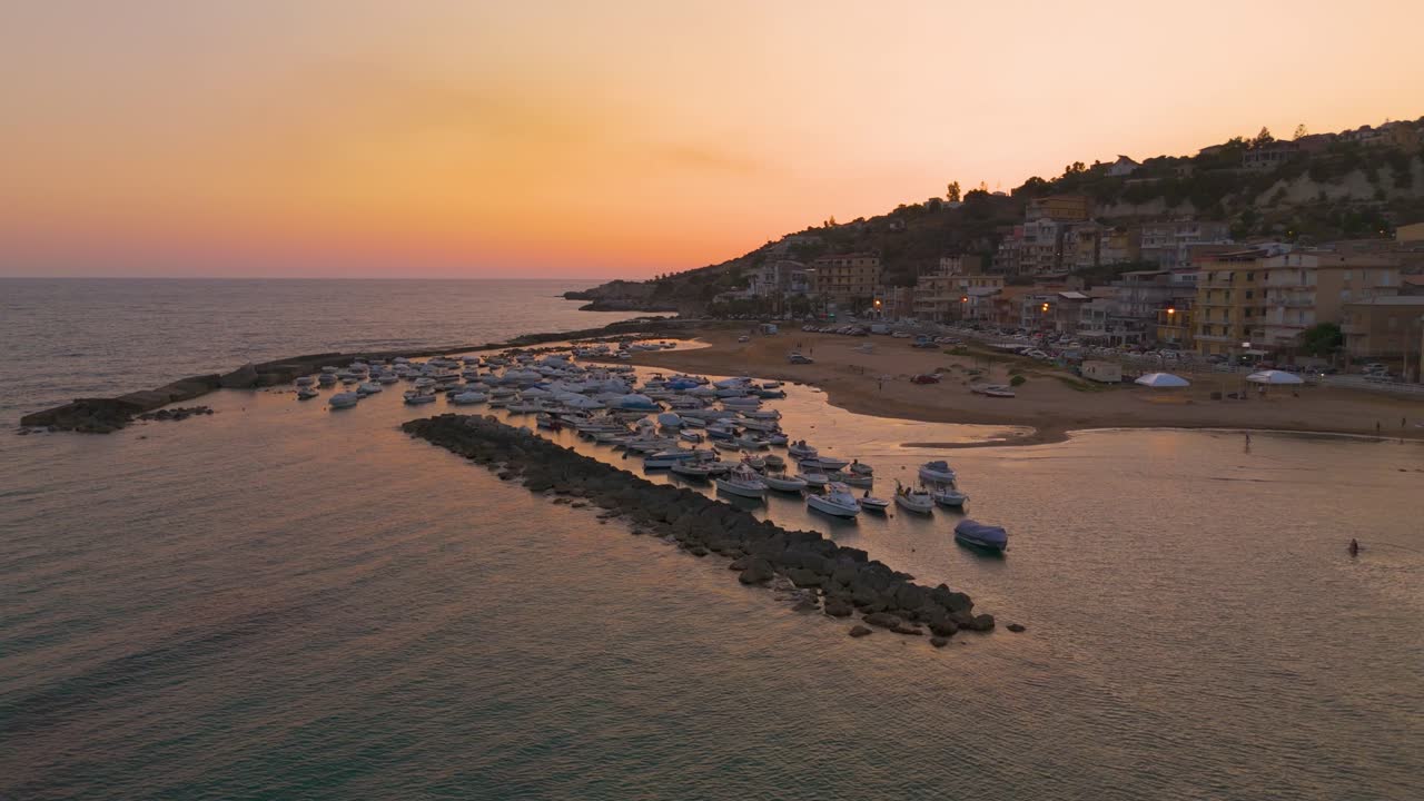 Serene sunset over Marina di Palma, Sicilia with boats and calm sea