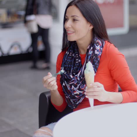 Woman-eating-an-ice-cream-in-a-parlor-or-cafe