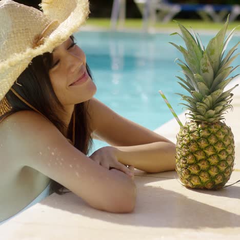 pretty trendy young woman in a summer pool