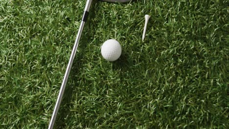 close up of golf club and ball on grass, copy space, slow motion