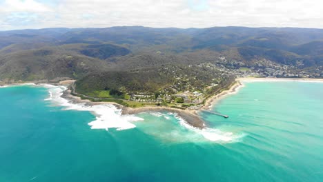 High-Aerial-bird's-eye-view-over-the-aqua-ocean-flying-towards-land