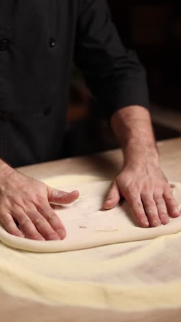 chef kneading pizza dough