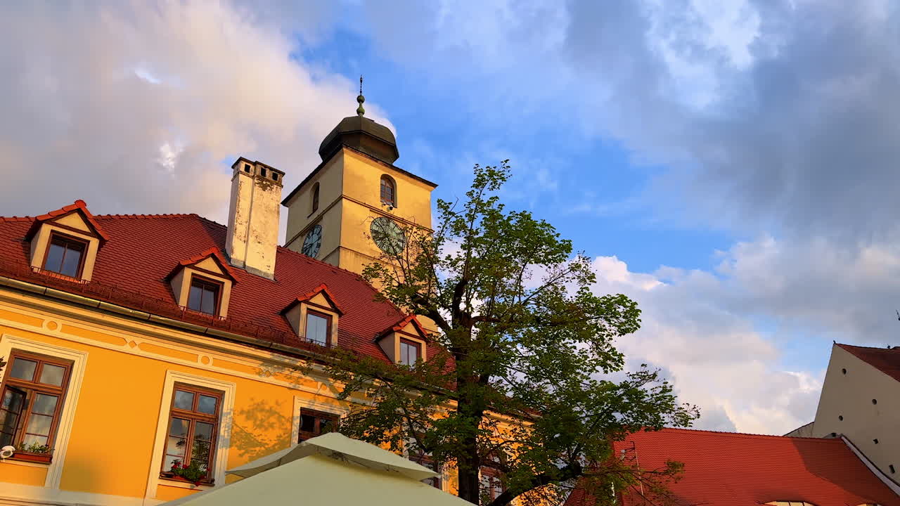 Council Tower of Sibiu at sunset. View of the historic Council Tower with red rooftops in Sibiu, Romania, during golden hour