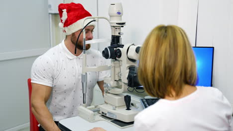 female ophthalmologist doing eye exam. doctor checking eyes with biomicroscope device